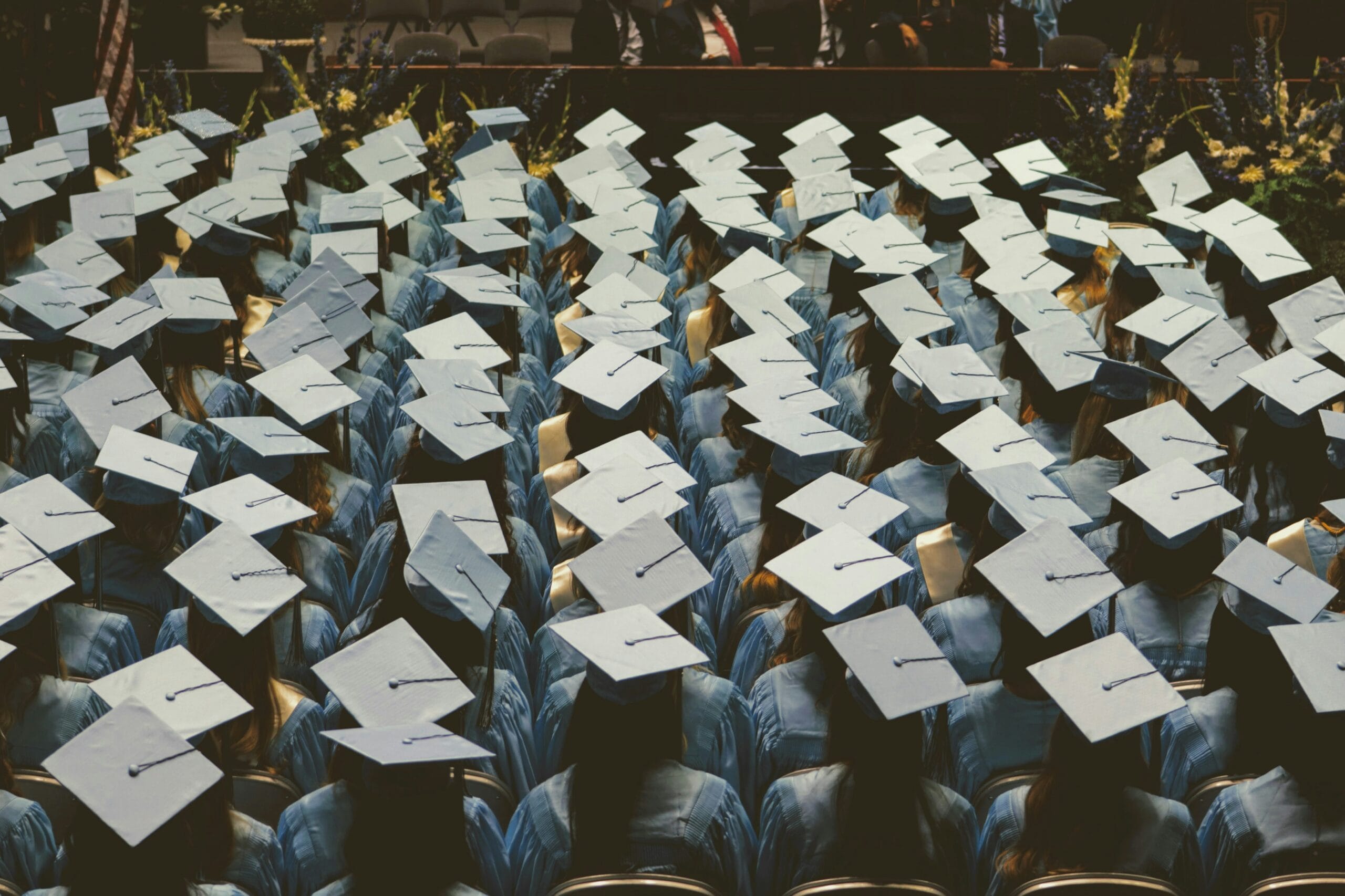 graduate students in blue academic hats